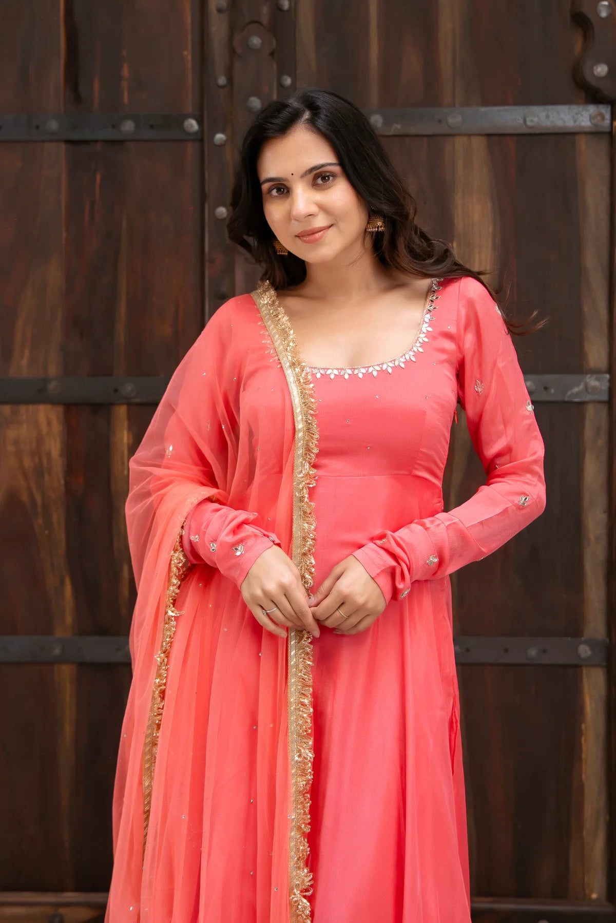 close up of mirror work neckline on coral pink anarkali suit
