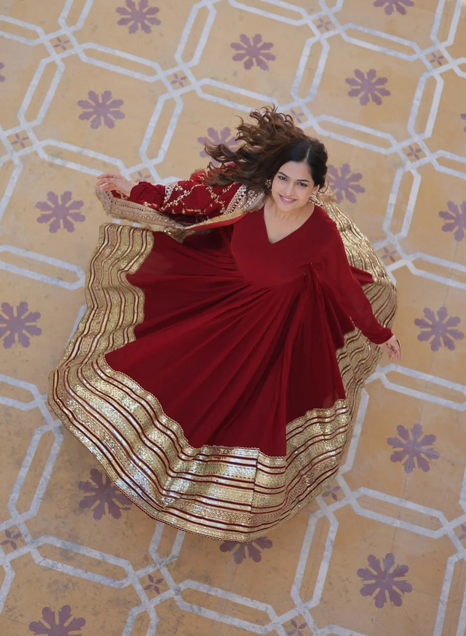 maroon gown for women overhead twirl with gold gota border