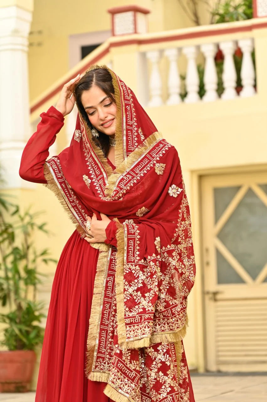 red anarkali gown with dupatta draped over head