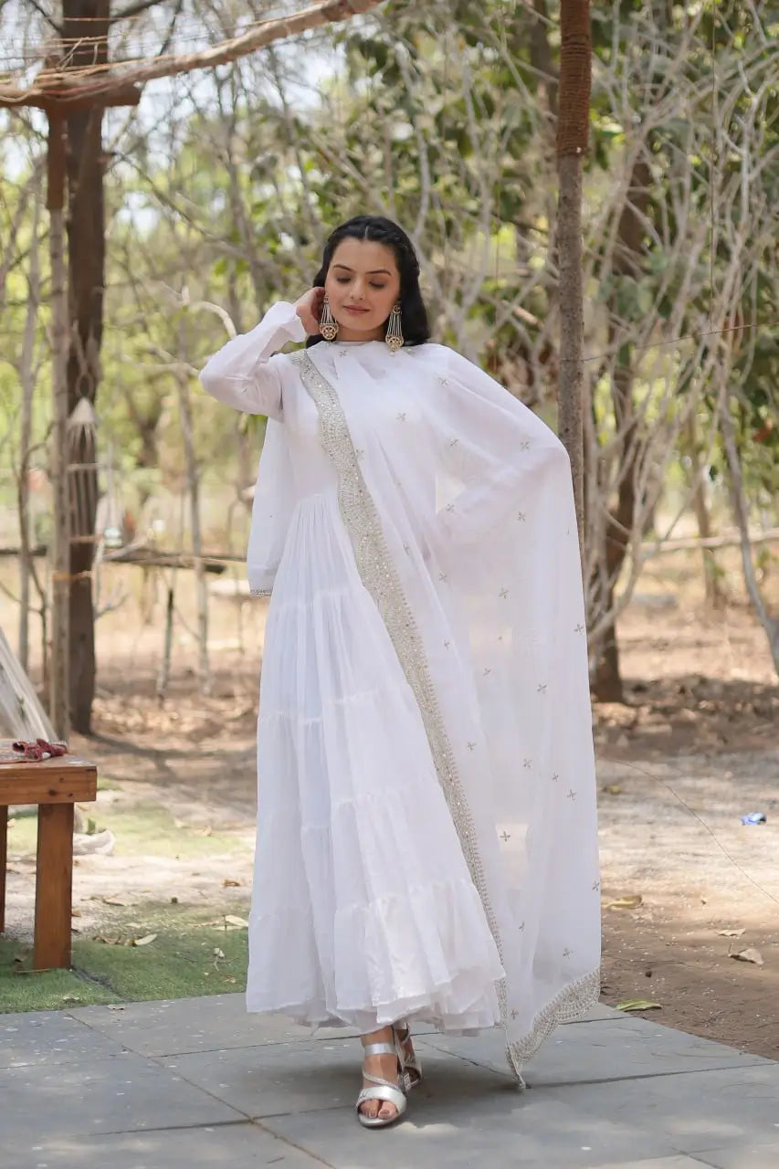 White tiered frill anarkali gown with gold sequin embroidered dupatta β model walking pose