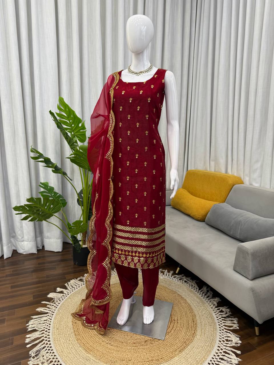 Mannequin wearing a red and gold traditional outfit