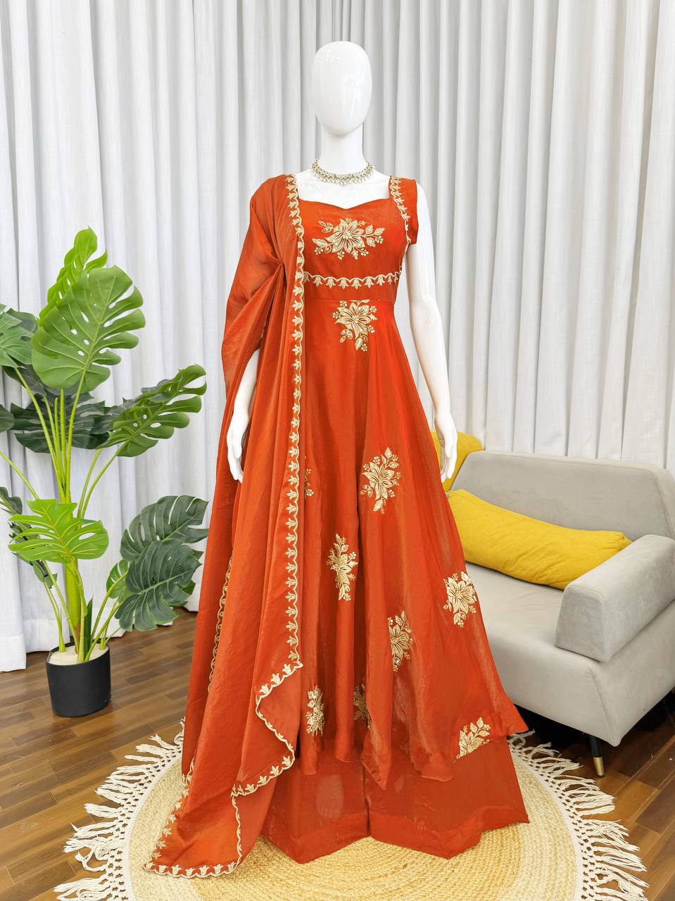 Close-up of rust orange embroidered Anarkali palazzo set with floral gold design full details