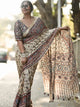 close up of cream ajrakh modal silk saree pallu mirror work and floral print