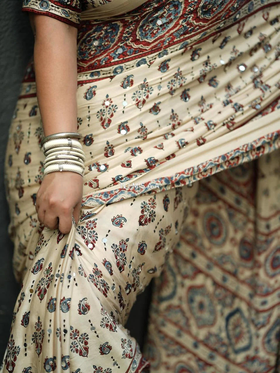 cream ajrakh modal silk saree drape with tassel pallu and ethnic border