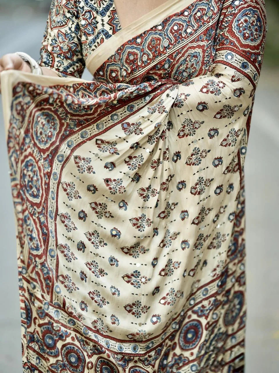 ajrakh modal silk saree in cream with real mirror work and ethnic print pallu