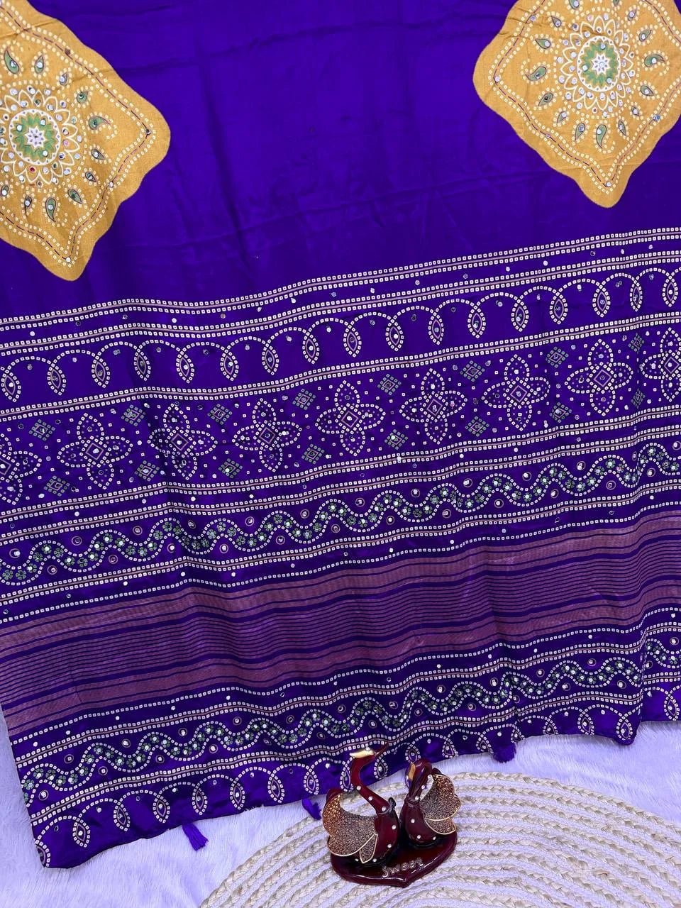 Ajrakh print saree purple with gold medallions mirror work border pallu closeup