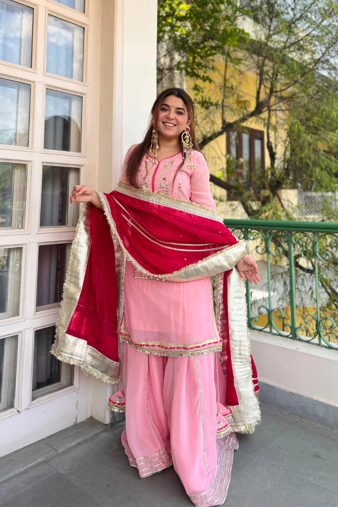 Baby pink organza silk sharara set with heavy sequin embroidery and embroidered lace sleeves