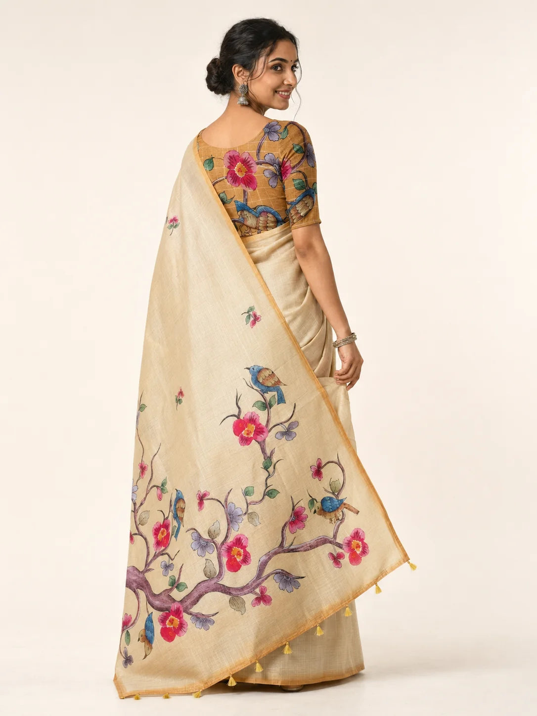back view of beige linen saree with bird and blossom printed pallu