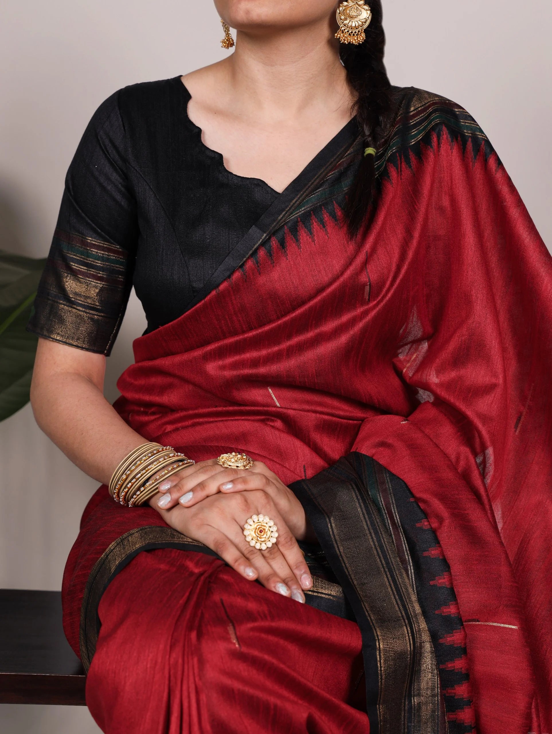red bhagalpuri silk saree black zari border seated model