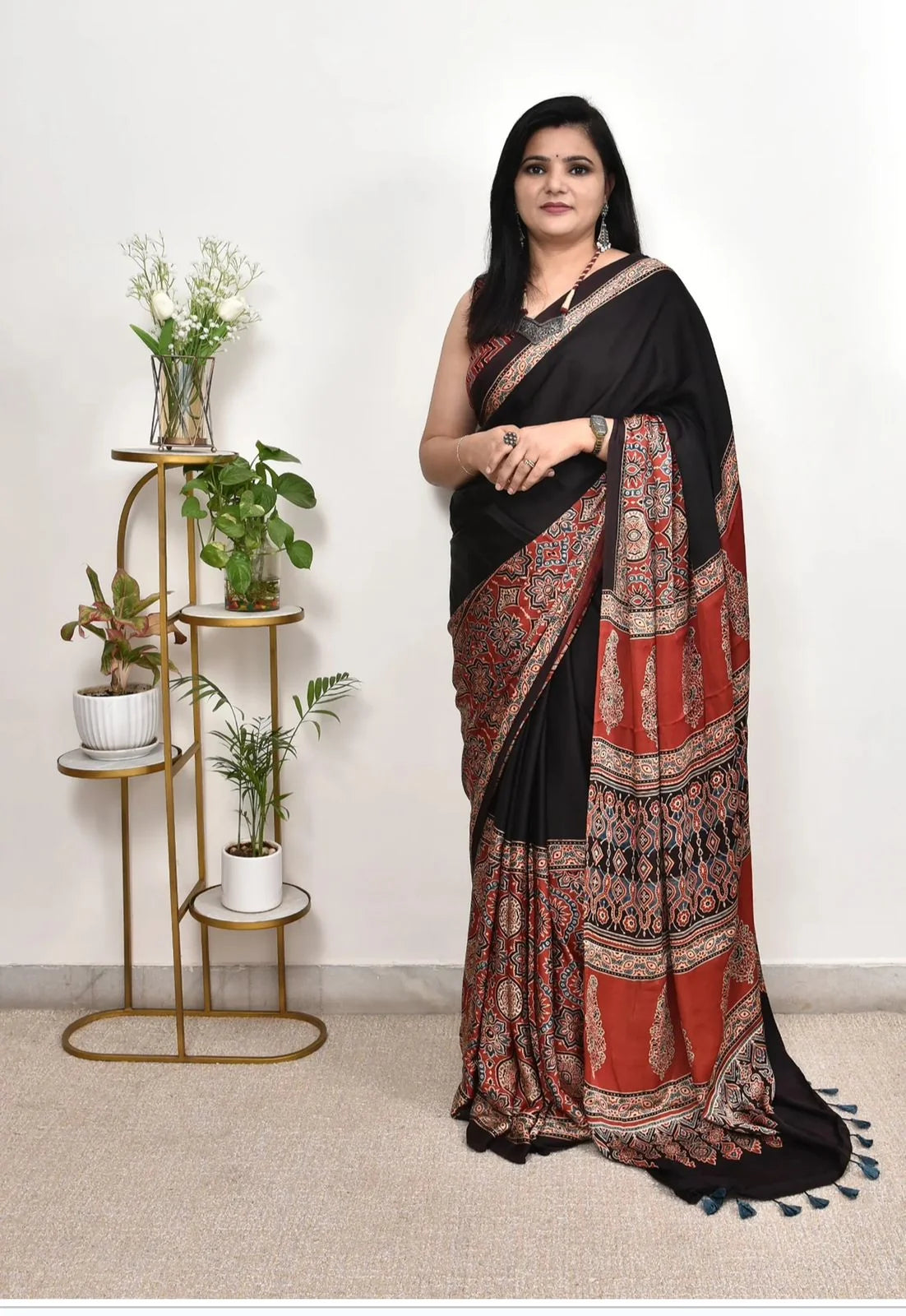 black ajrakh print saree with maroon ethnic printed border and tassel pallu