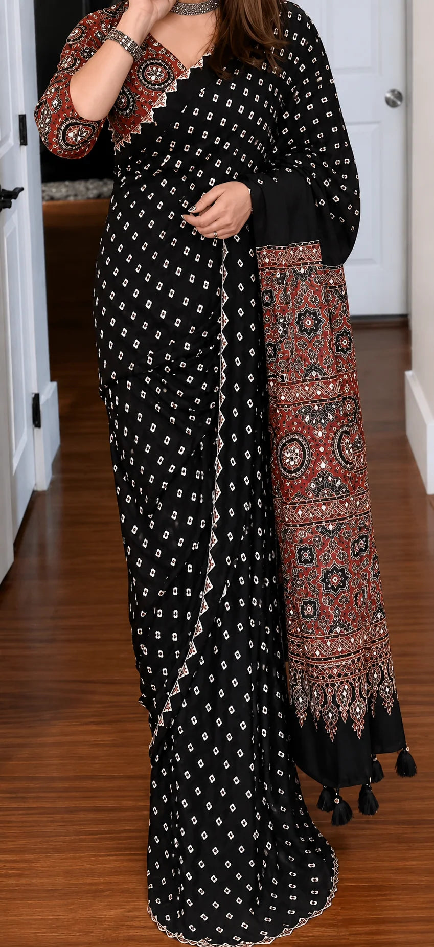 close up of black ajrakh saree bandhani print body and mirror work blouse