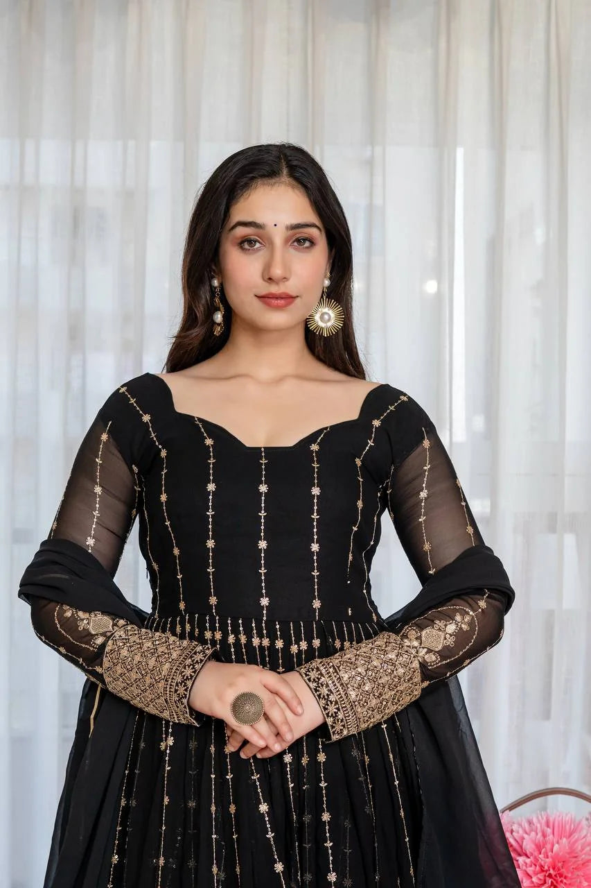 Black anarkali suit close-up showing heavy gold zari and sequin embroidery on faux blooming