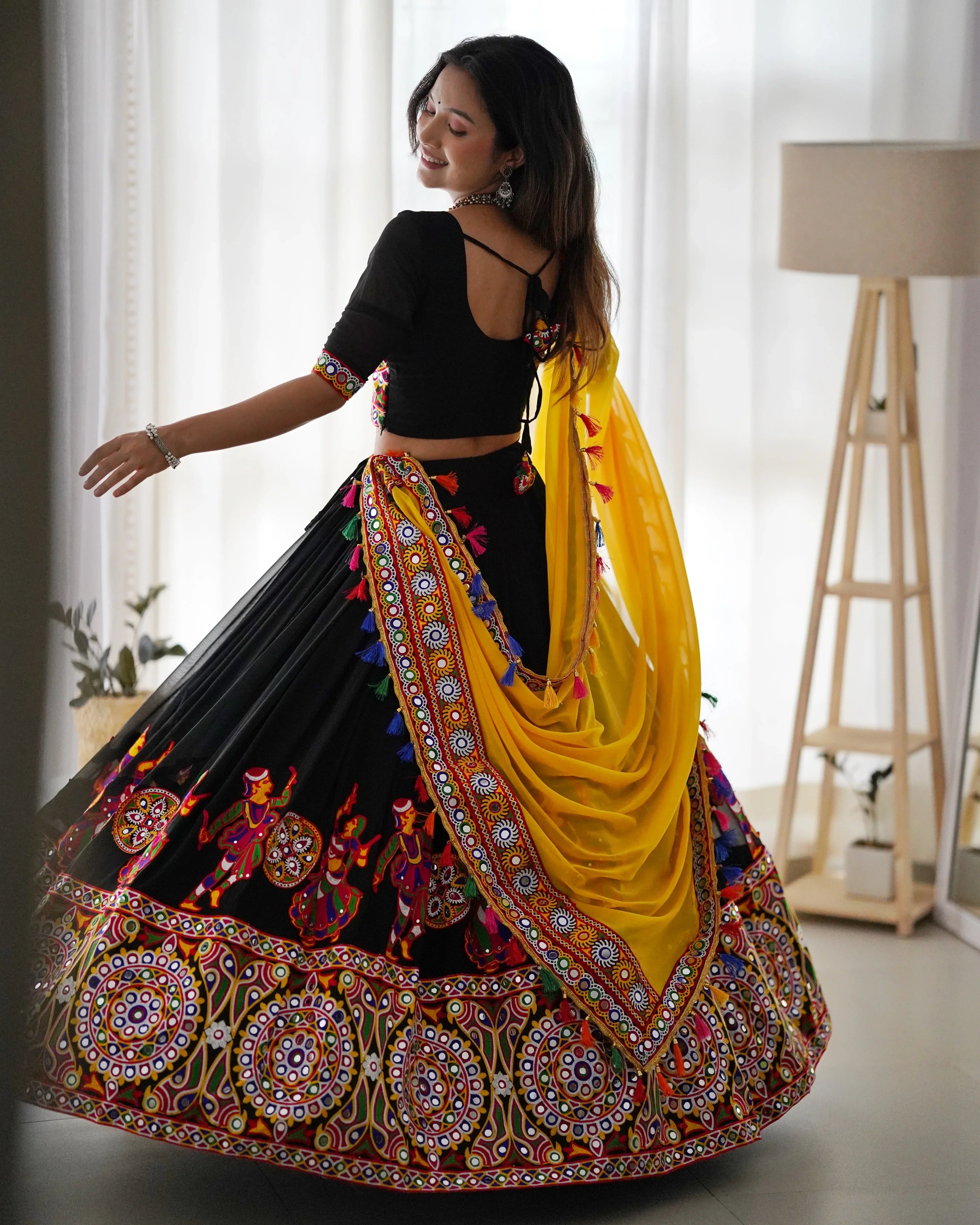Black chaniya choli set with yellow dupatta side-back view Navratri lehenga Kayara Label