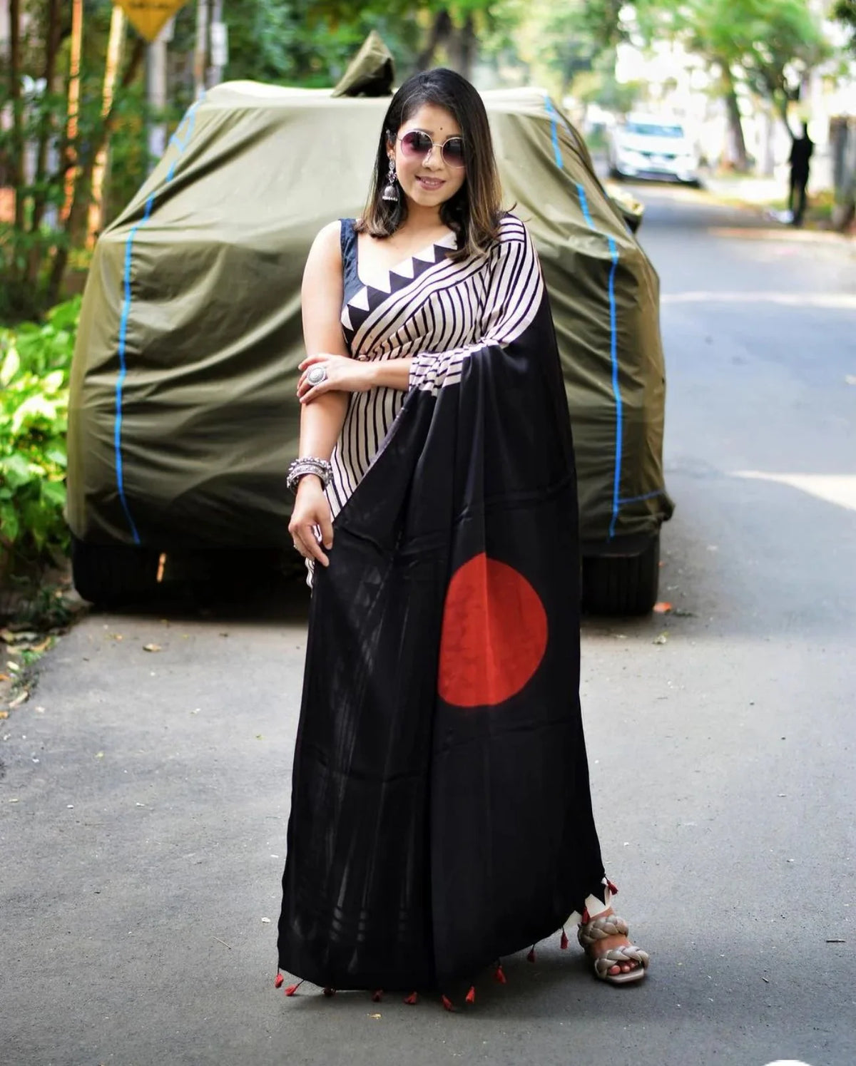black and white striped saree with black pallu and red circle motif drape