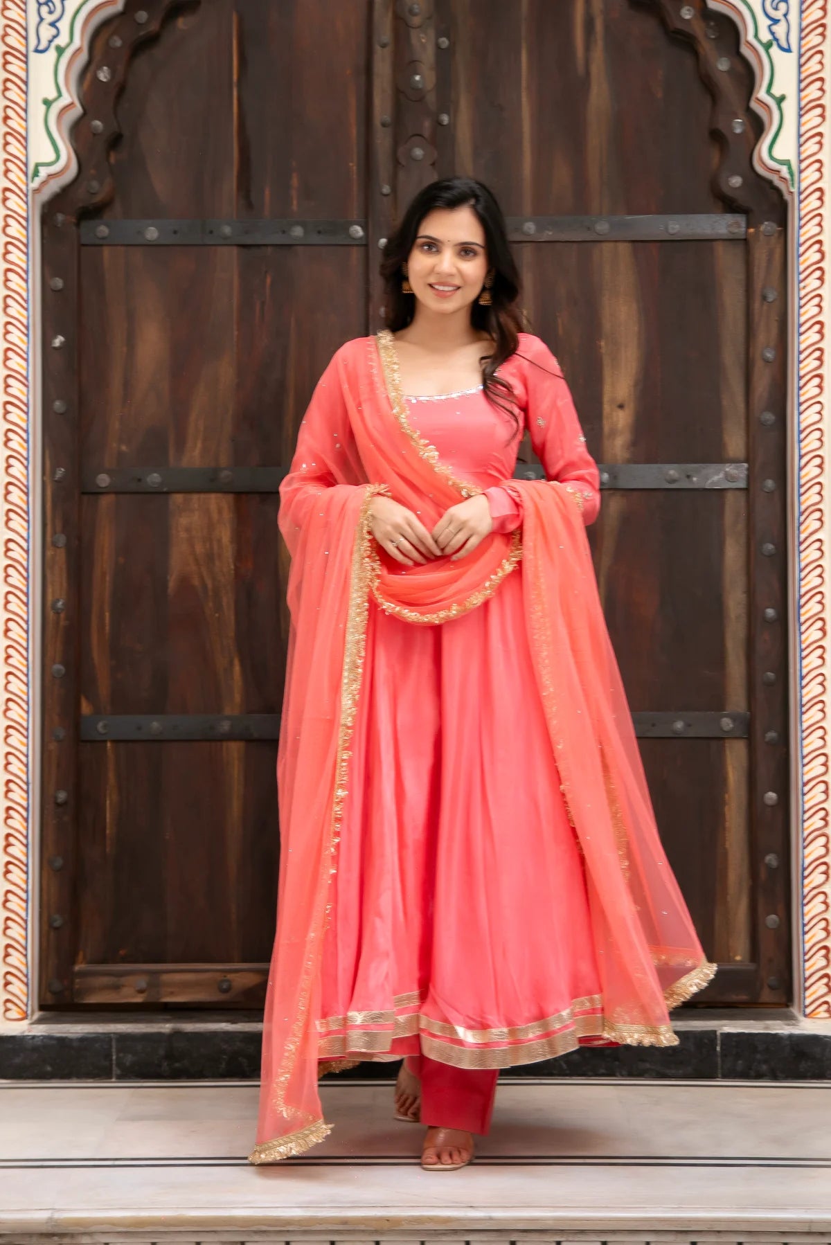 coral pink chinon anarkali set with mirror work and gold border dupatta