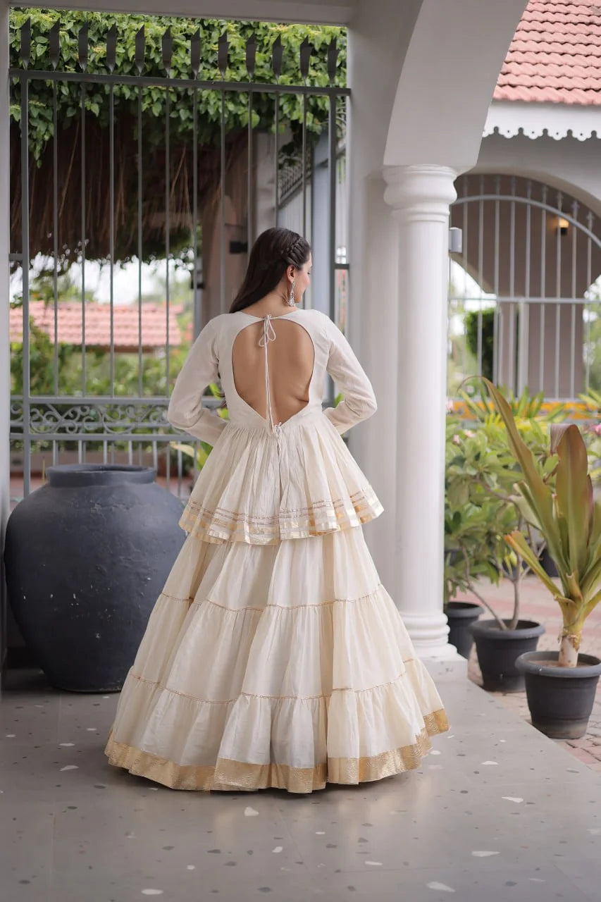 Off white navratri lehenga choli back view – open-back dori and tiered frill skirt