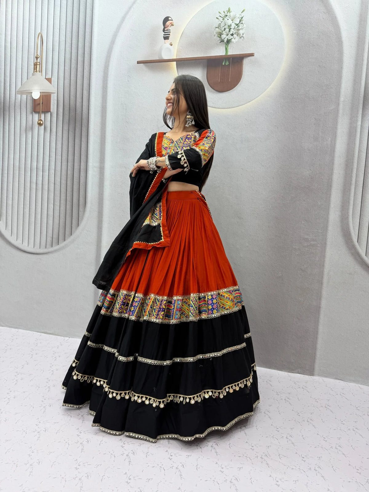Cotton navratri chaniya choli showing big flair with gota and mirror lace tiers - garba pose