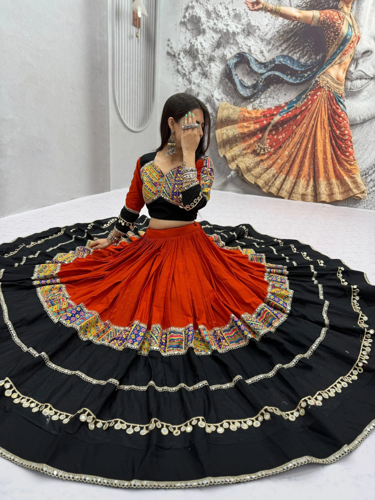 Full cotton navratri chaniya choli with orange black tiered skirt and mirror choli - standing view