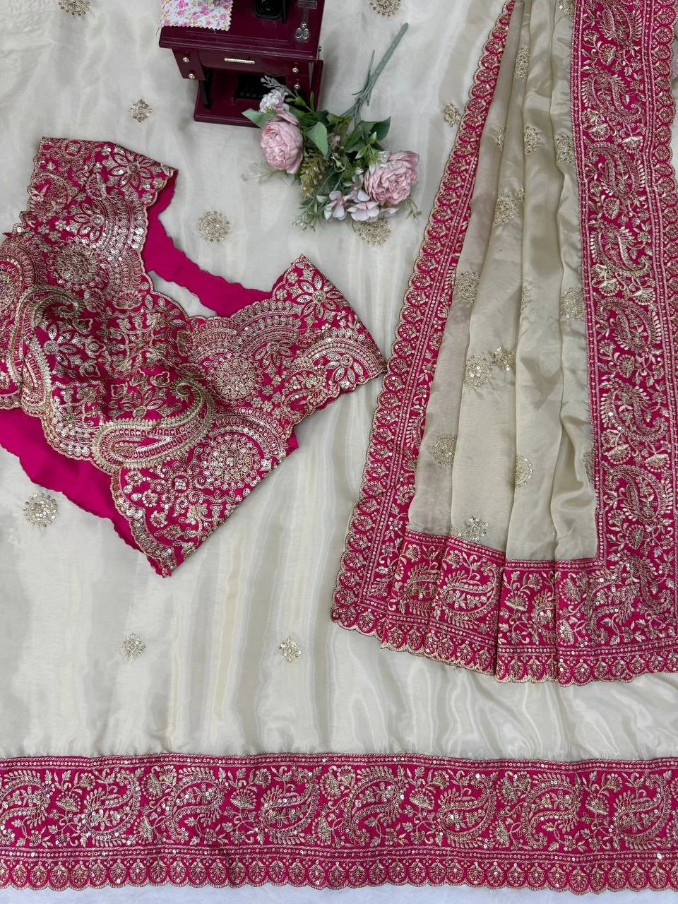 cream organza silk saree flat lay thread sequin embroidered border detail closeup