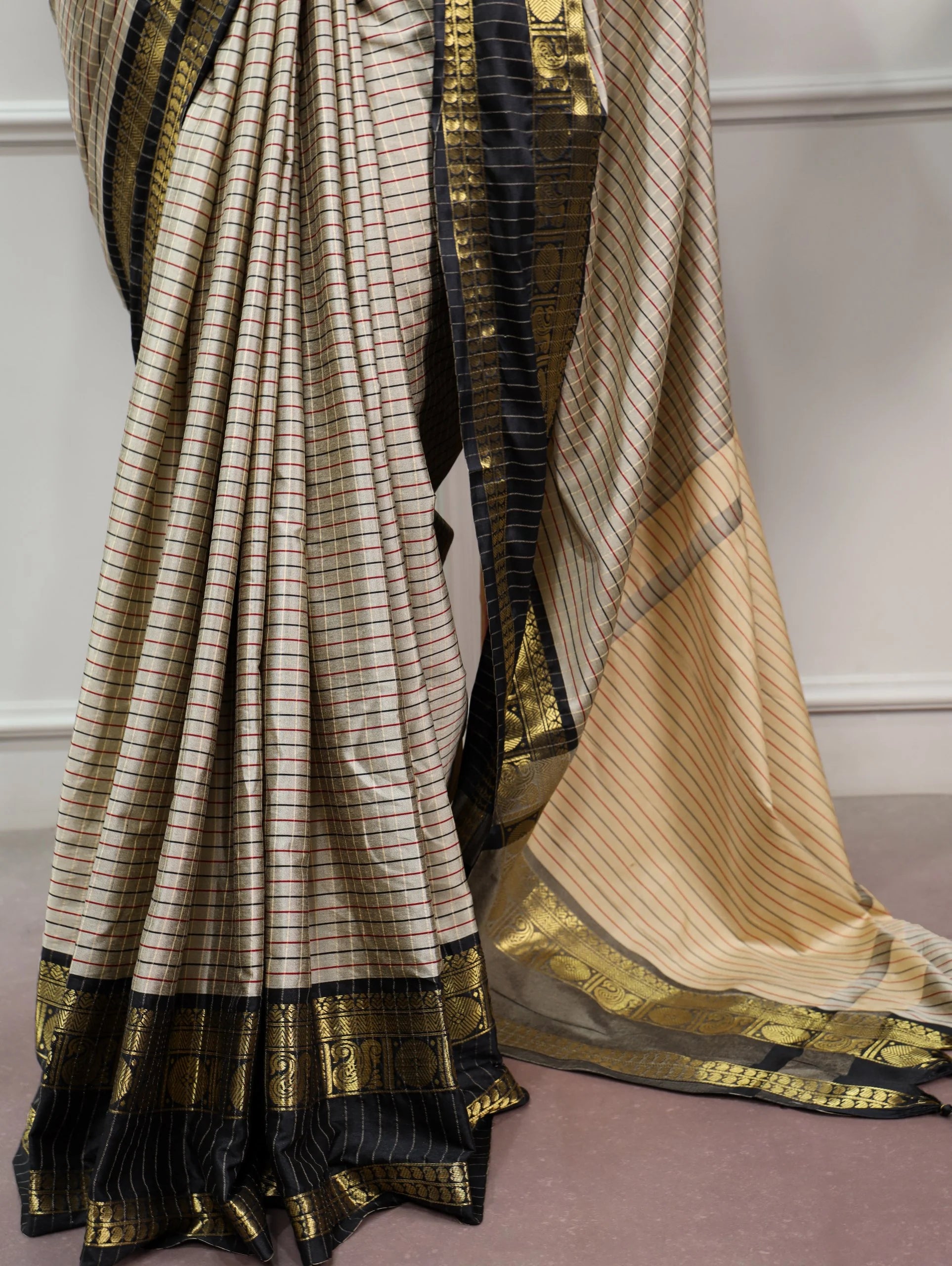 Cream checks silk saree fabric close-up black red grid weave with ornate zari border
