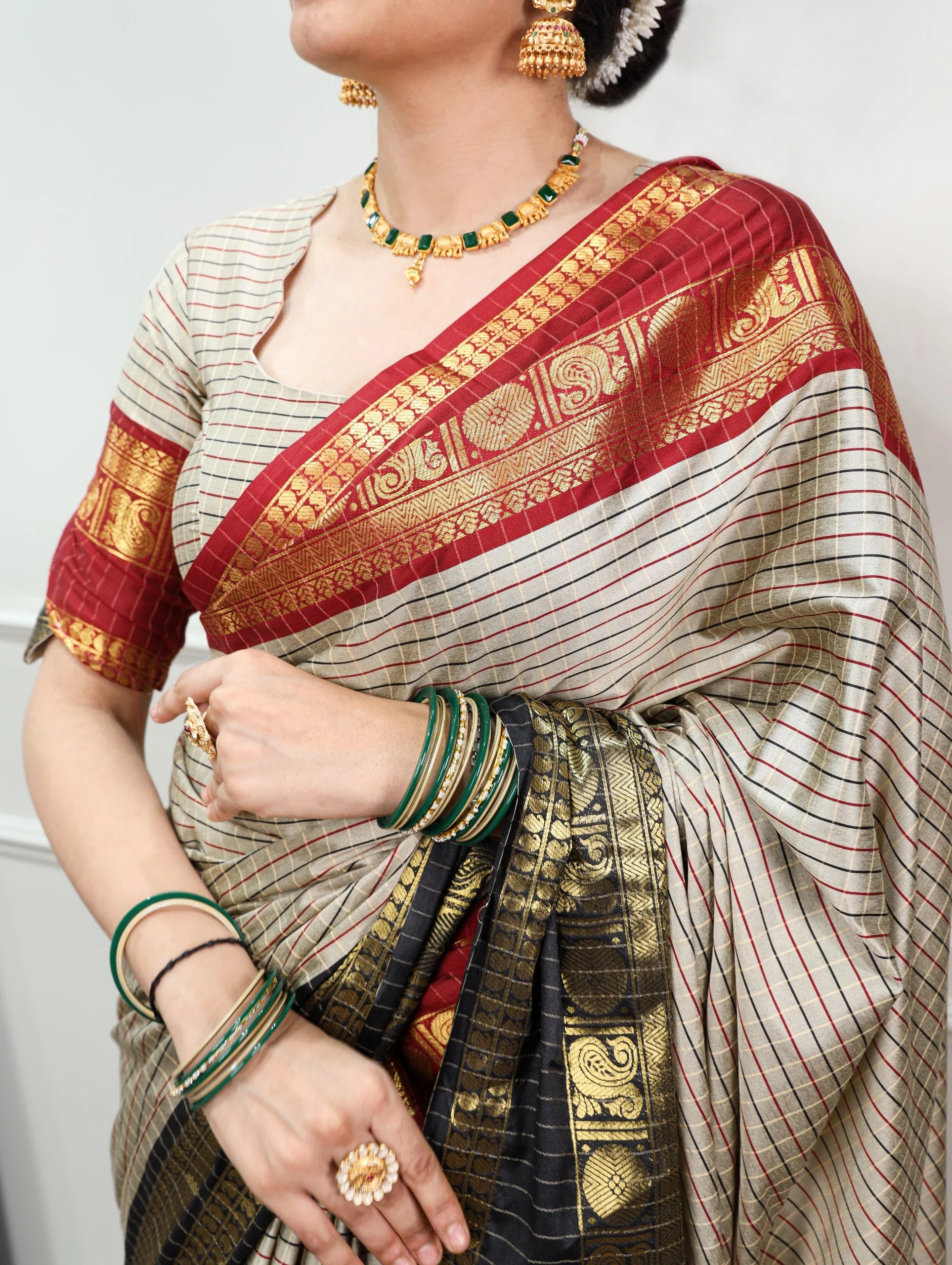 Cream silk saree red pallu zari buta work gold motifs and matching checks blouse drape