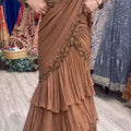Dusty rose lehenga saree with gold embroidery and layered ruffle skirt – front view