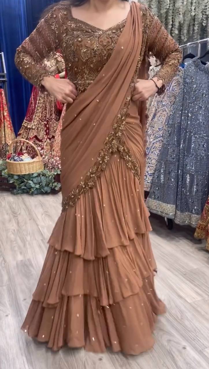 Dusty rose lehenga saree with gold embroidery and layered ruffle skirt – front view
