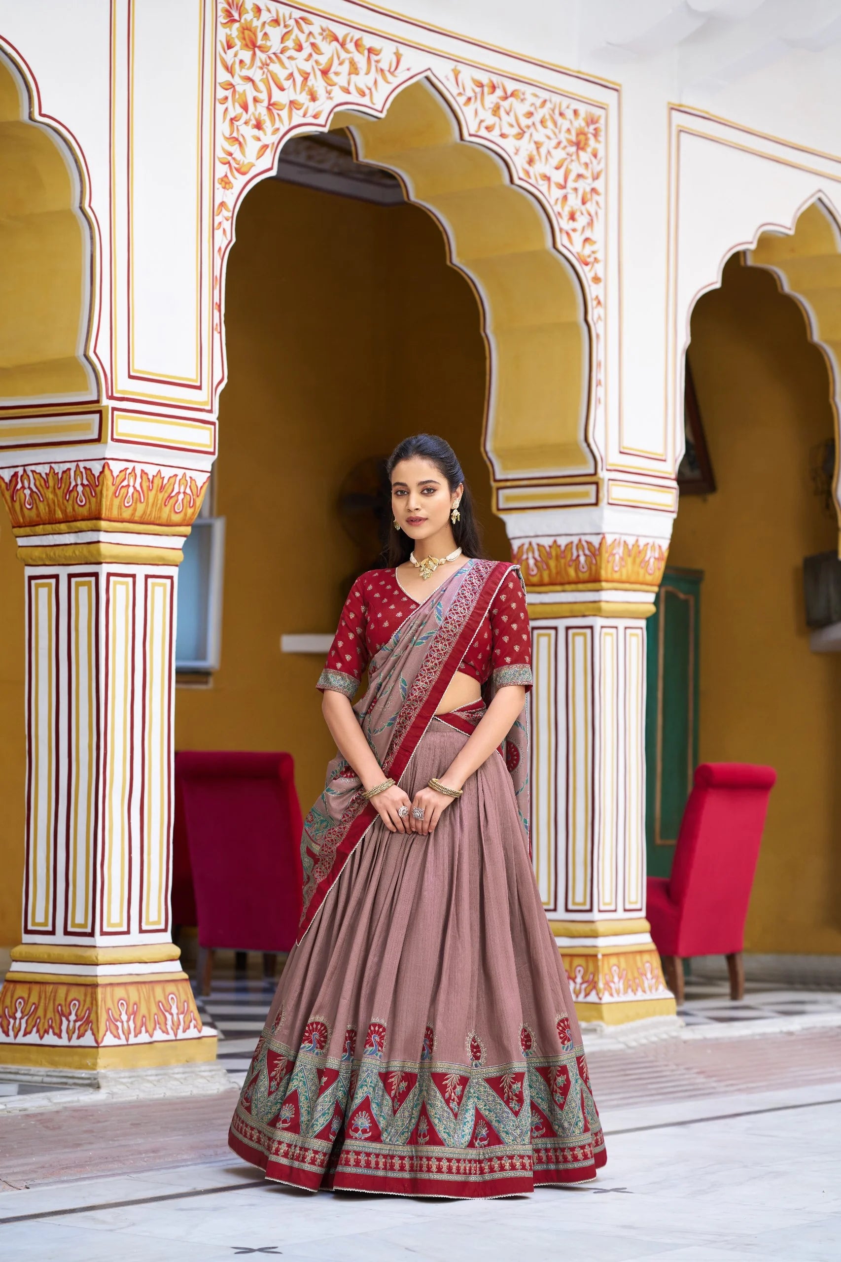 Sage green lehenga choli set seated showing peacock block print border