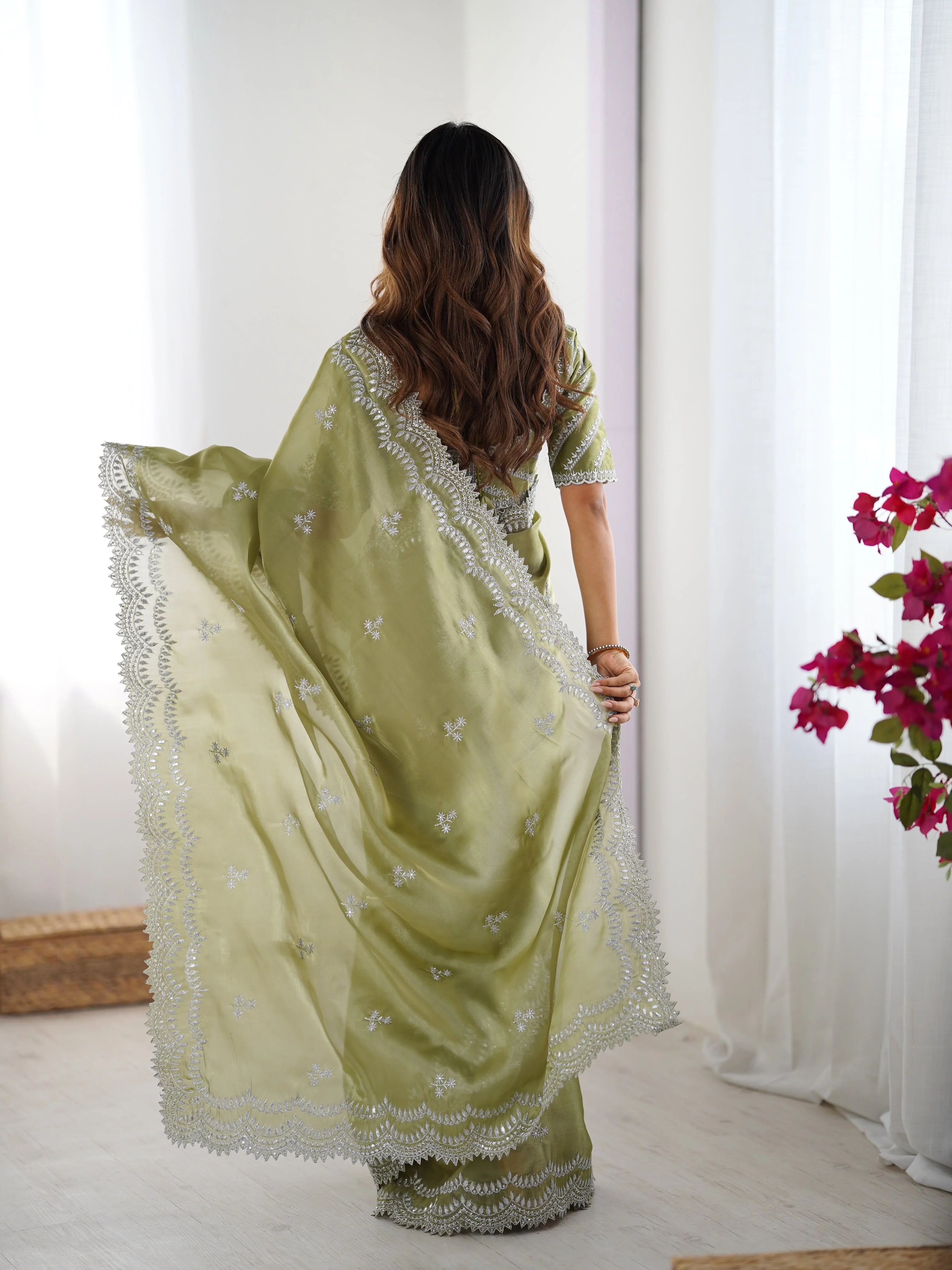 Pista green georgette saree — back view with pallu flared showing scalloped border