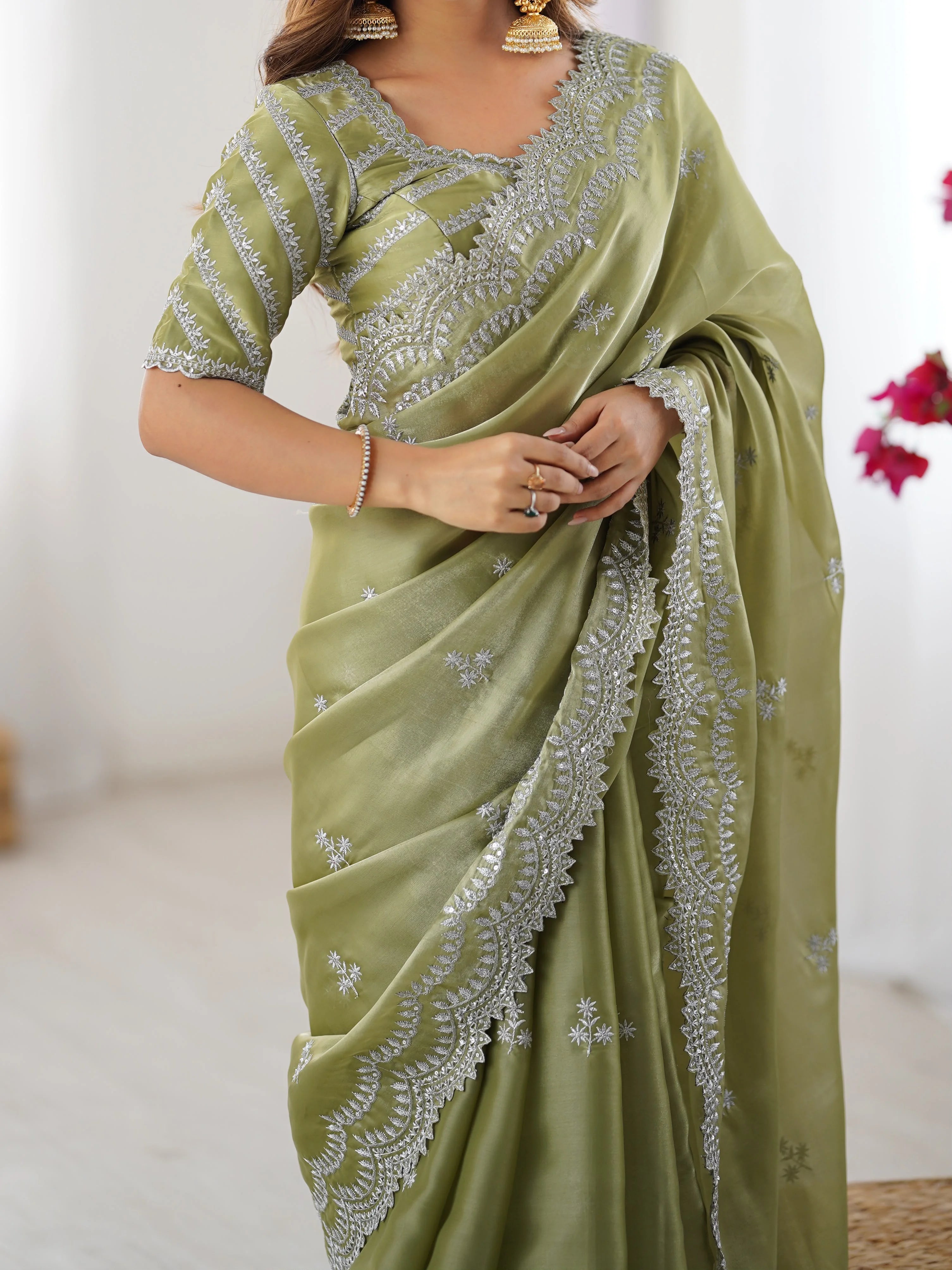 Faux georgette saree pista green — close-up of silver arch embroidery and scattered butas