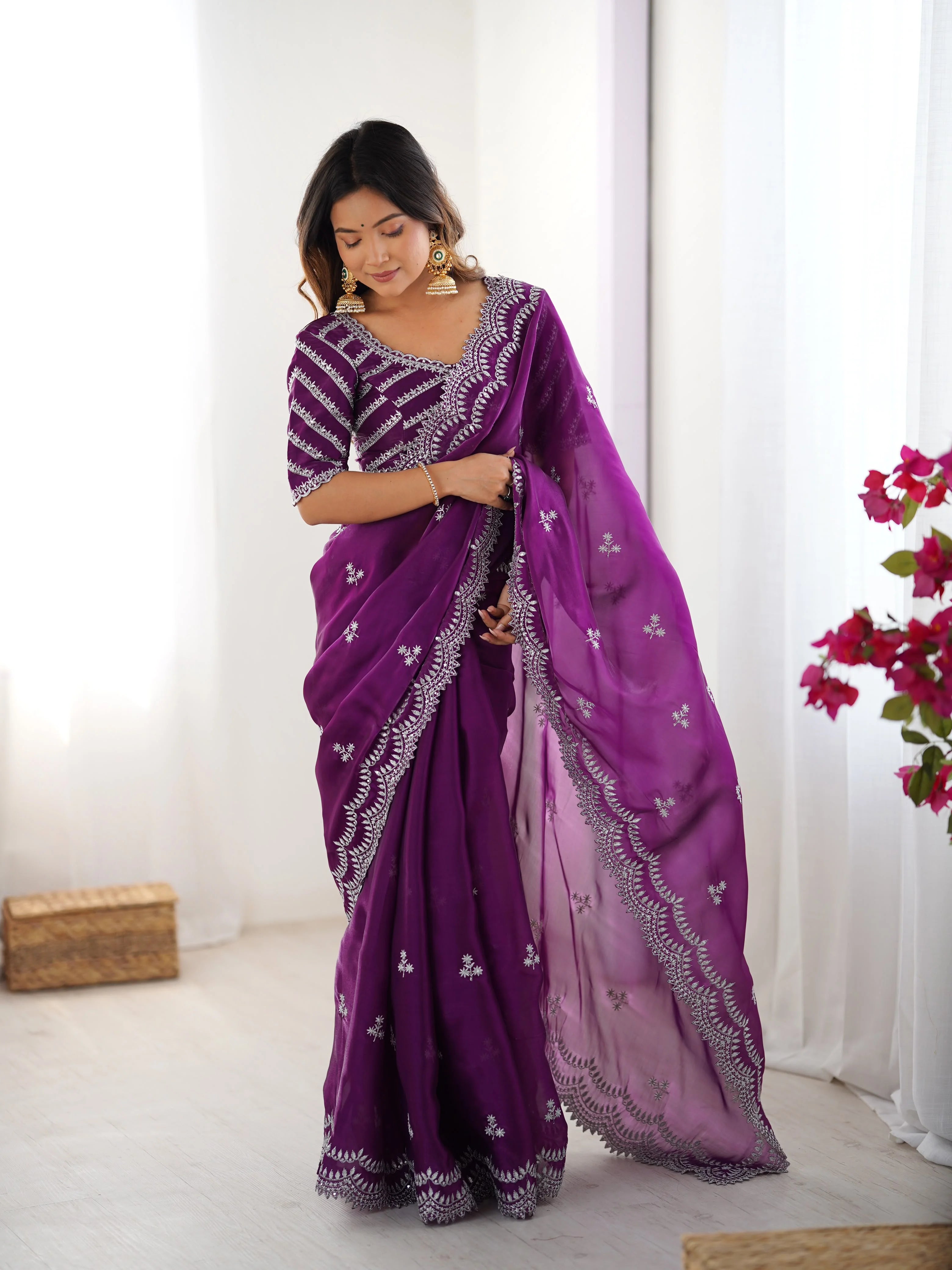 Heavy faux georgette saree purple — model looking down showing border embroidery detail