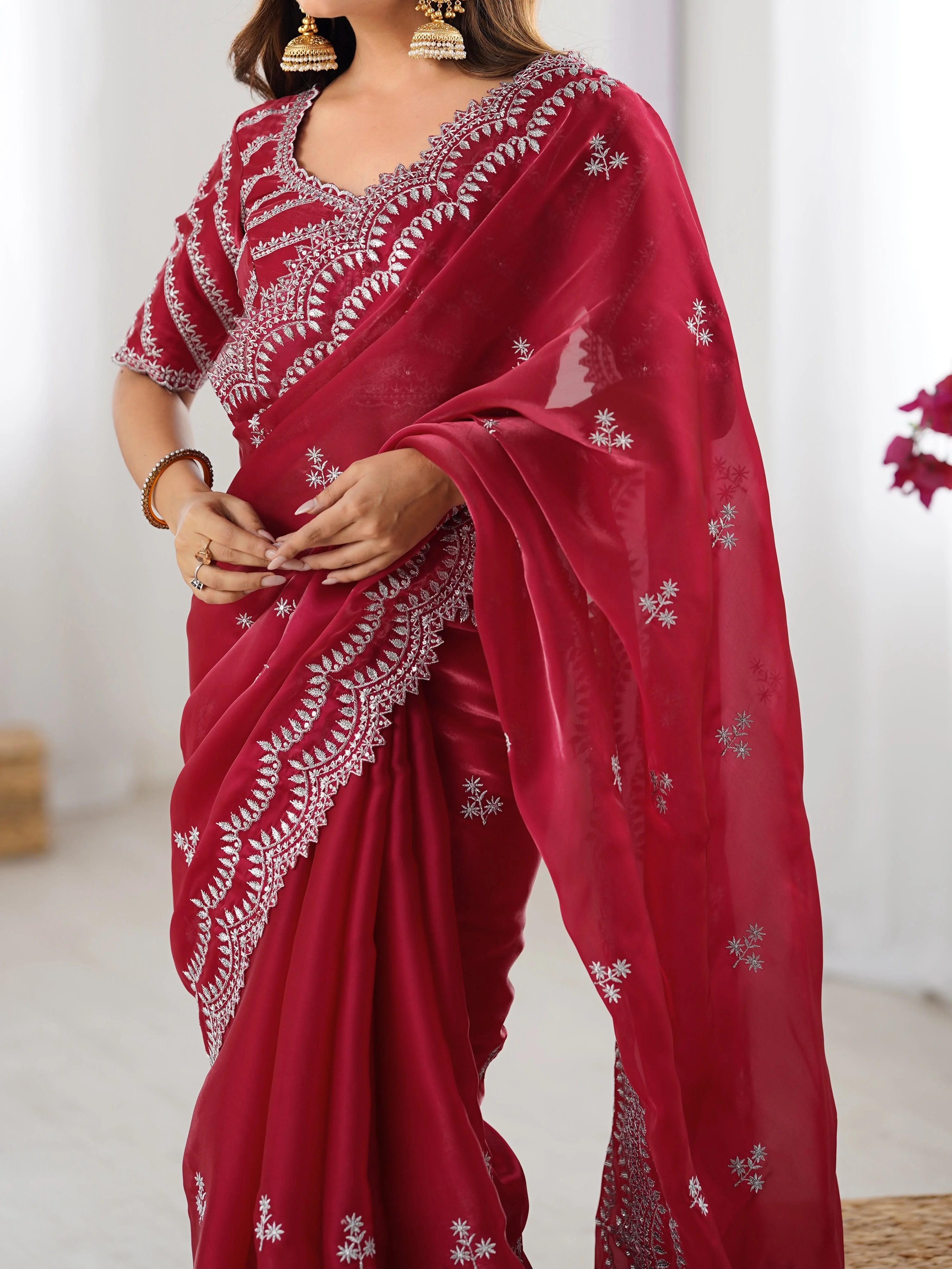 Red faux georgette saree with thread embroidery — close-up of scalloped arch border work