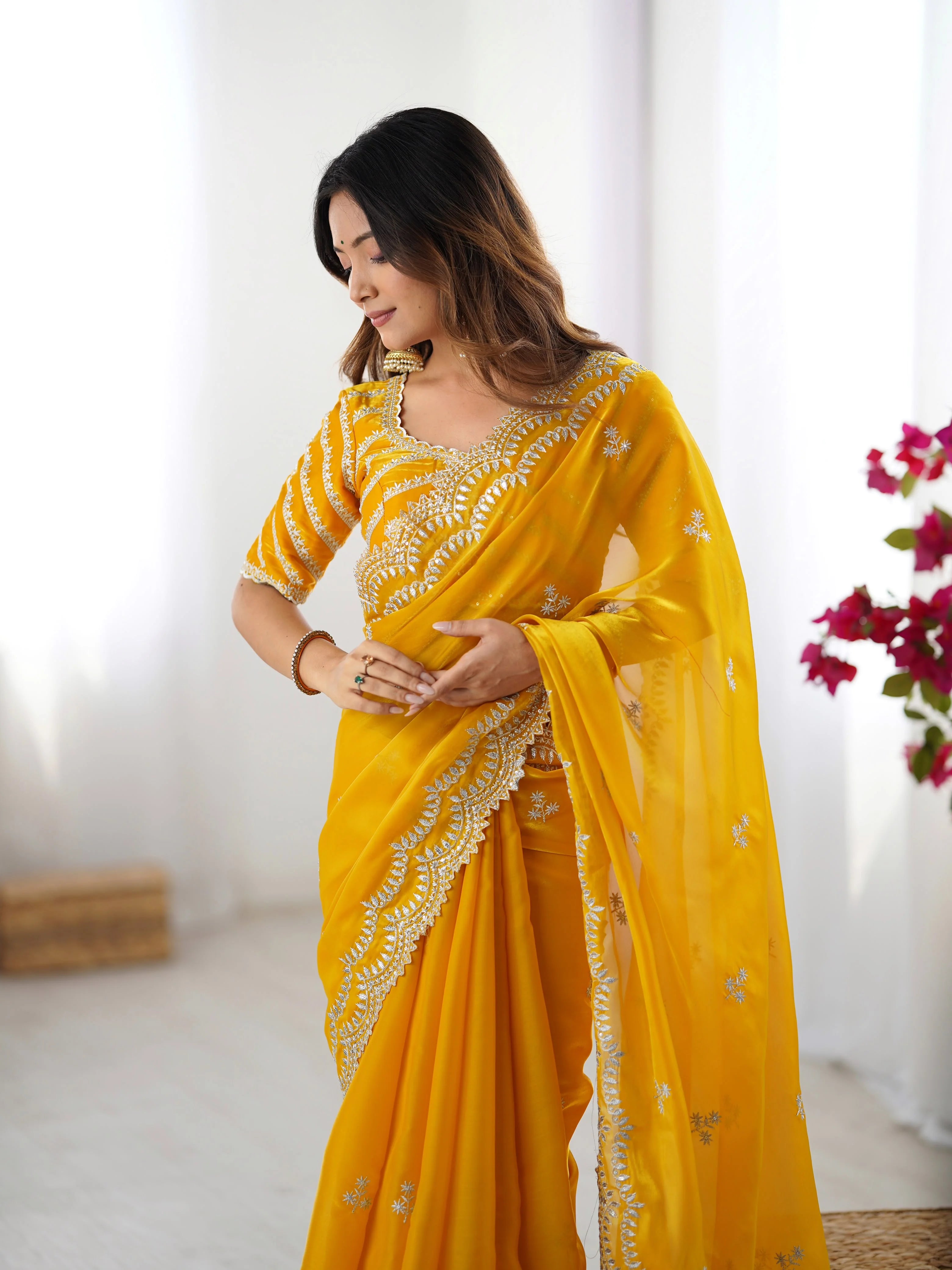 Faux georgette saree red — flat lay showing full scalloped arch border and scattered butas