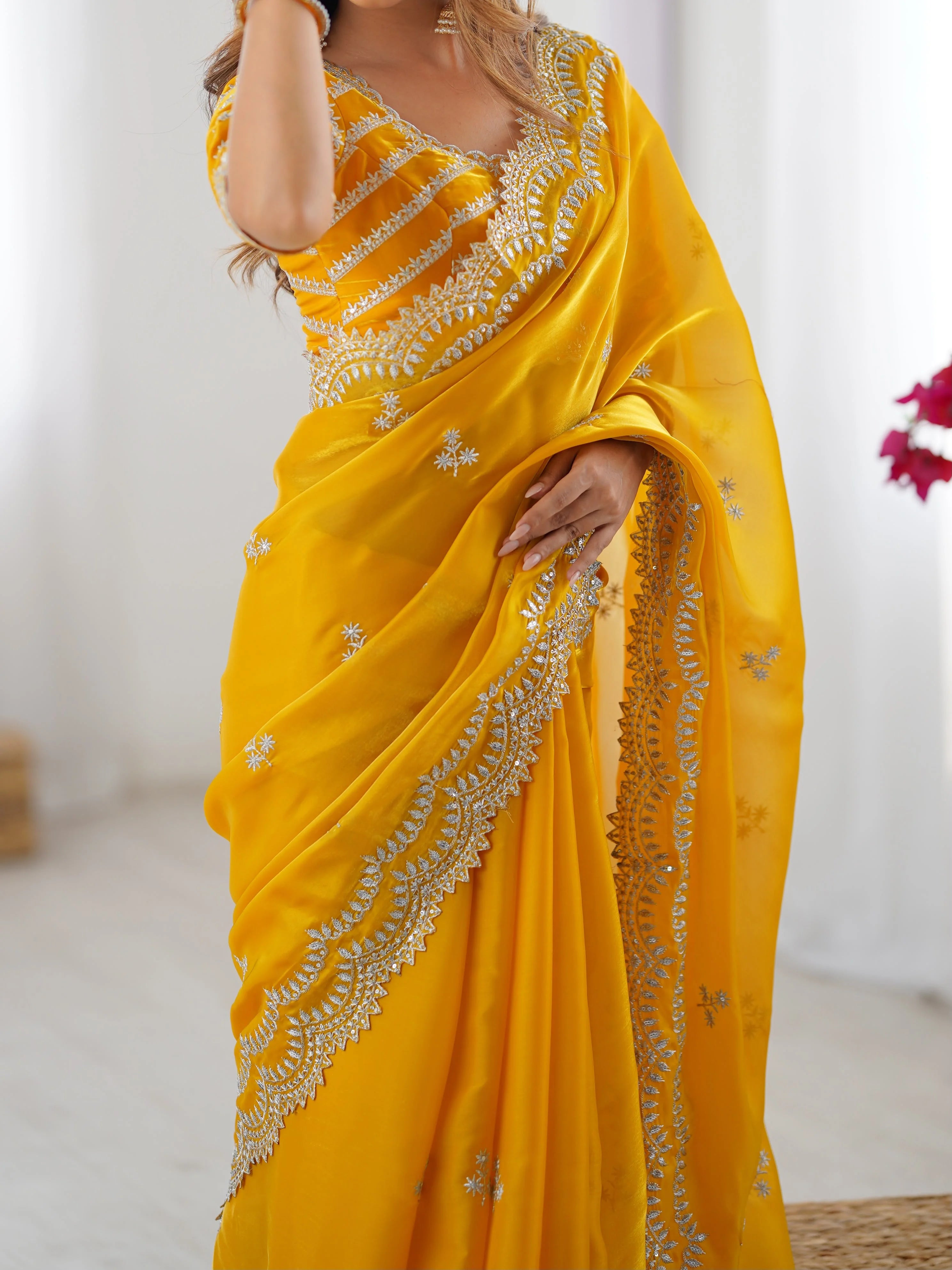 Yellow faux georgette saree thread embroidery — close-up of ornate scalloped arch border