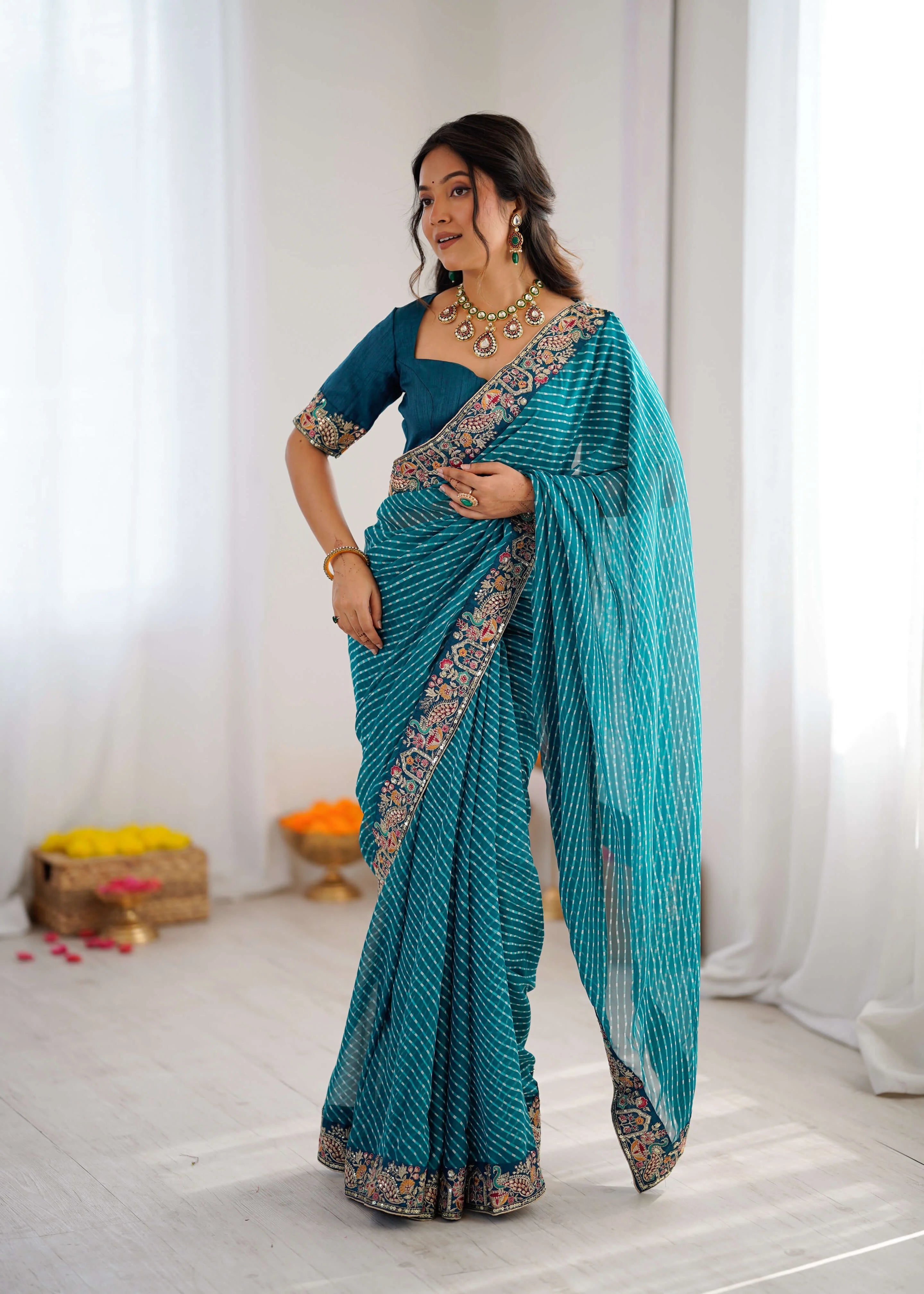 teal georgette leheriya saree with embroidered border front
