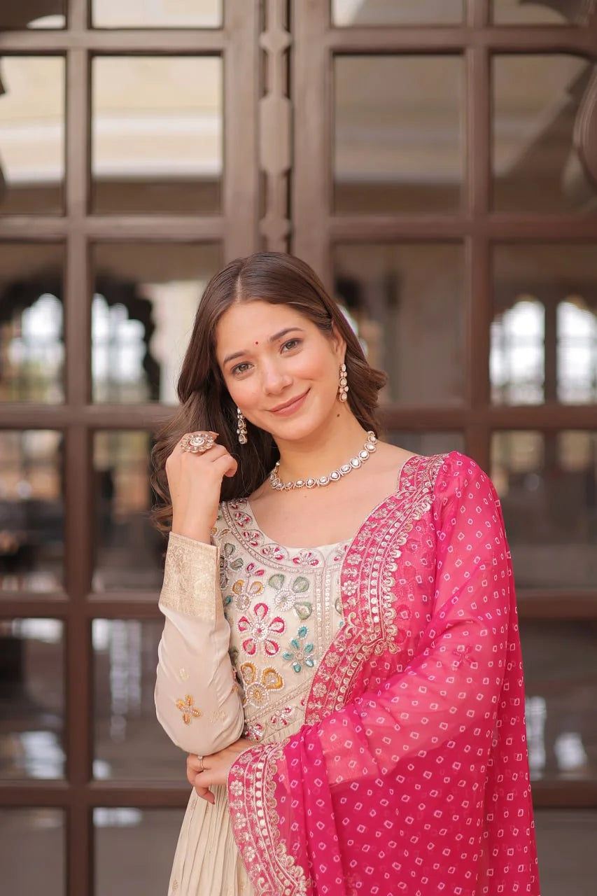 ivory jacquard gown with purple bandhani dupatta held out