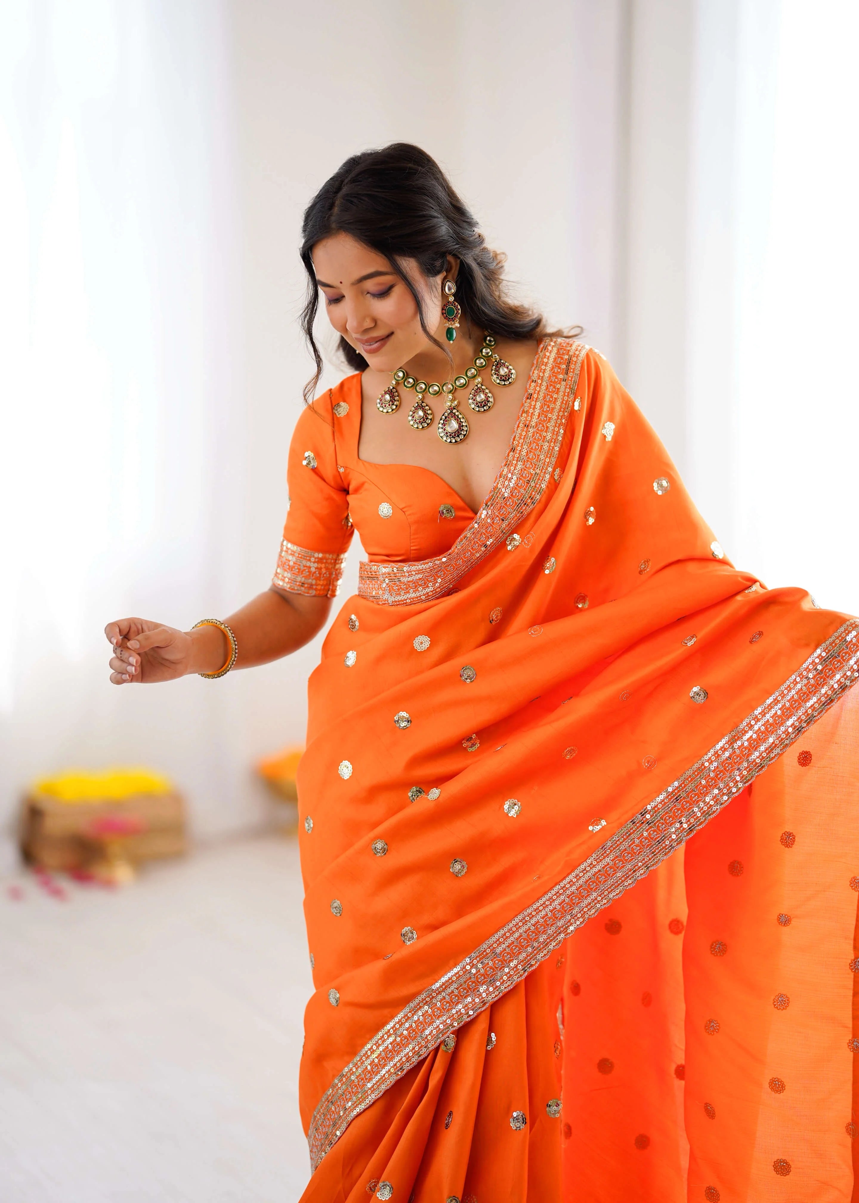 Designer orange georgette saree with sequin border festive look