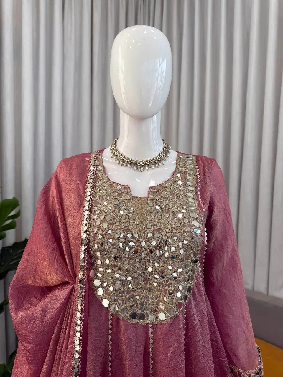 Pink Anarkali gown with mirror work and gold embroidery, perfect for ethnic occasions