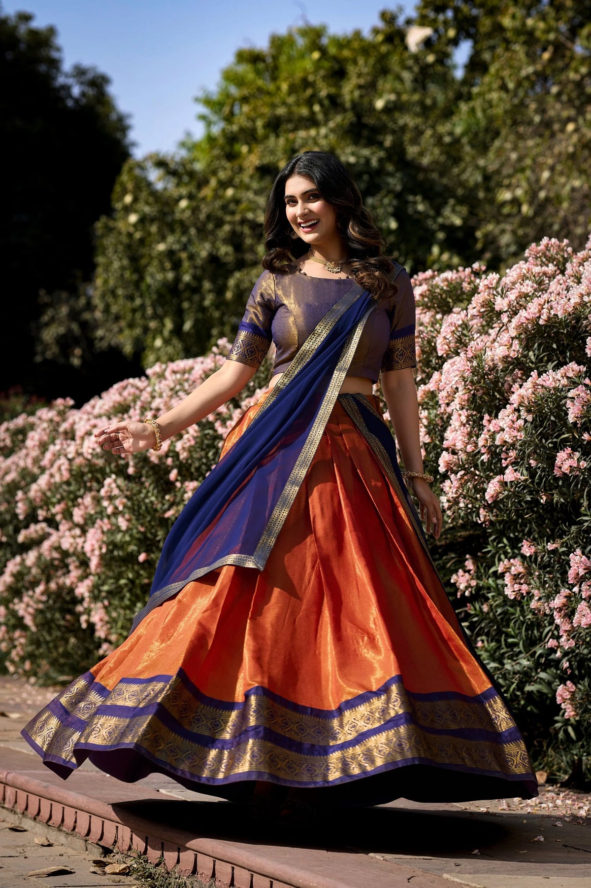 Kanchipuram half saree lehenga set orange navy blue twirl showing full 3.70m flare