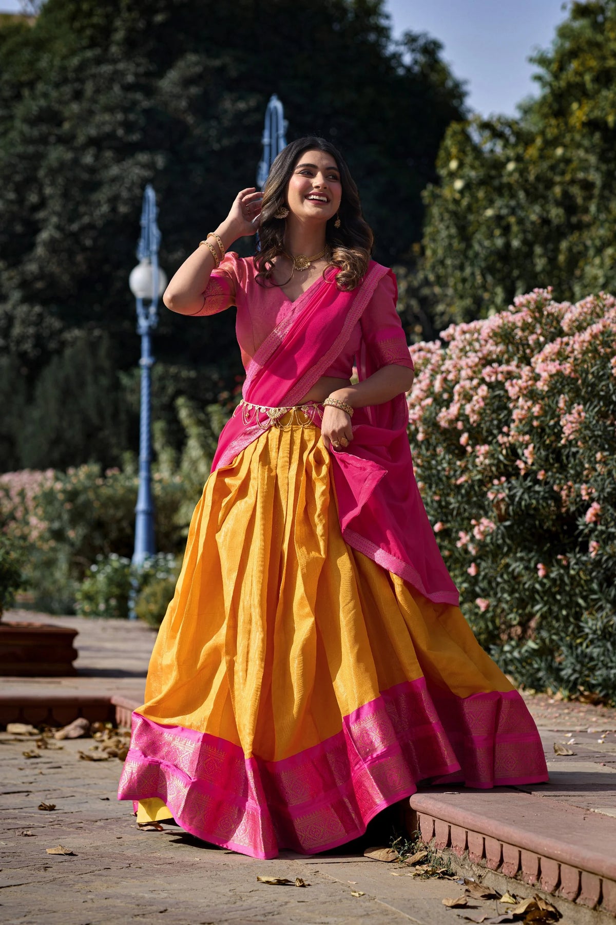 Purple and teal Kanchipuram half saree lehenga set front view with gold zari border