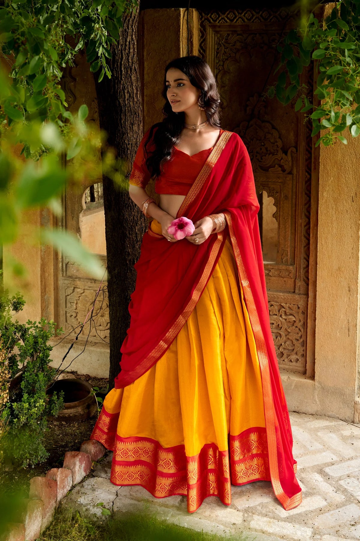Cream and pink Kanchipuram lehenga set outdoor garden view with dupatta