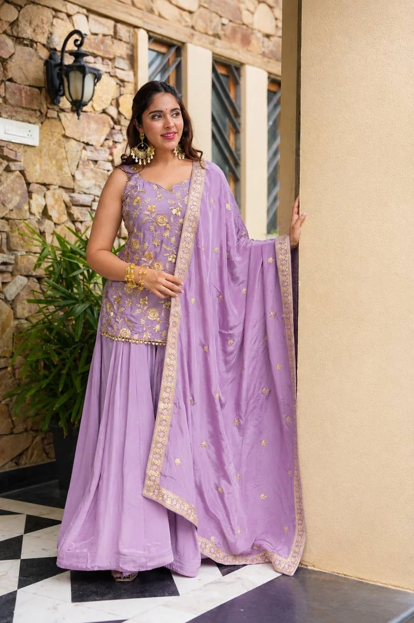 3/4 view of lavender sharara set with gold floral sequin embroidery and dupatta