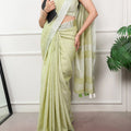 pistachio green linen saree zari border full body view with tote bag