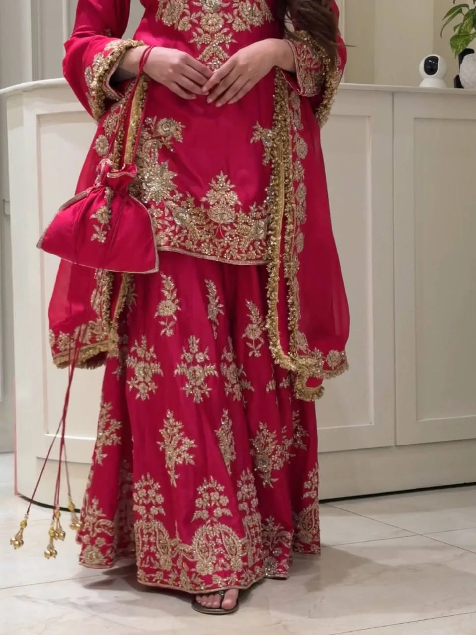 Close-up of gold thread and sequin embroidery on magenta chinon silk sharara