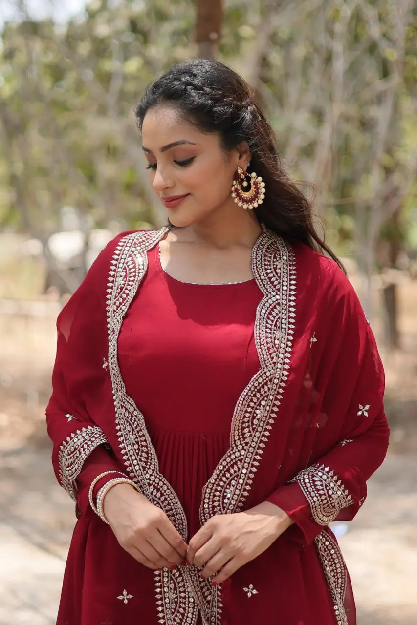 Close-up of maroon anarkali gown with gold sequin embroidered scallop dupatta border detail