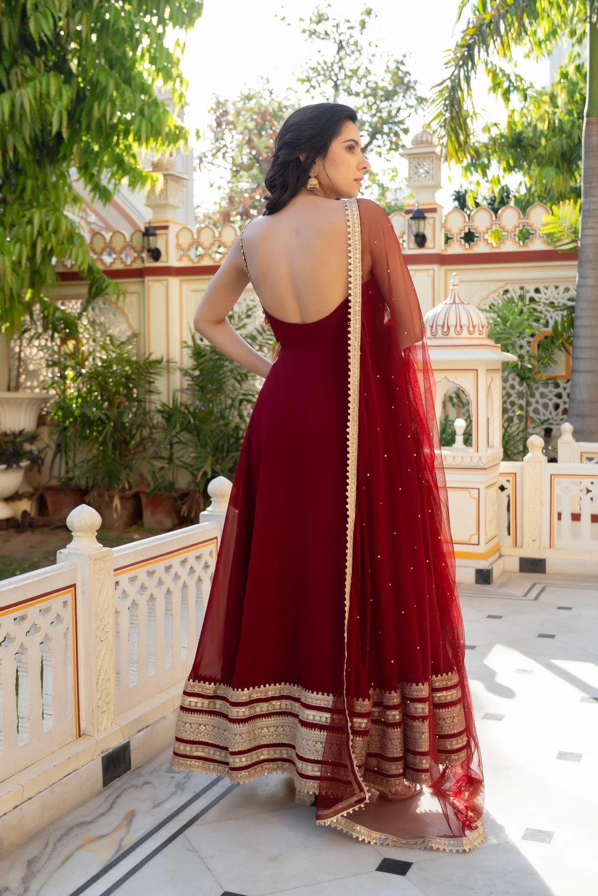 Maroon georgette anarkali gown with open back and gold zari border and net dupatta - back view