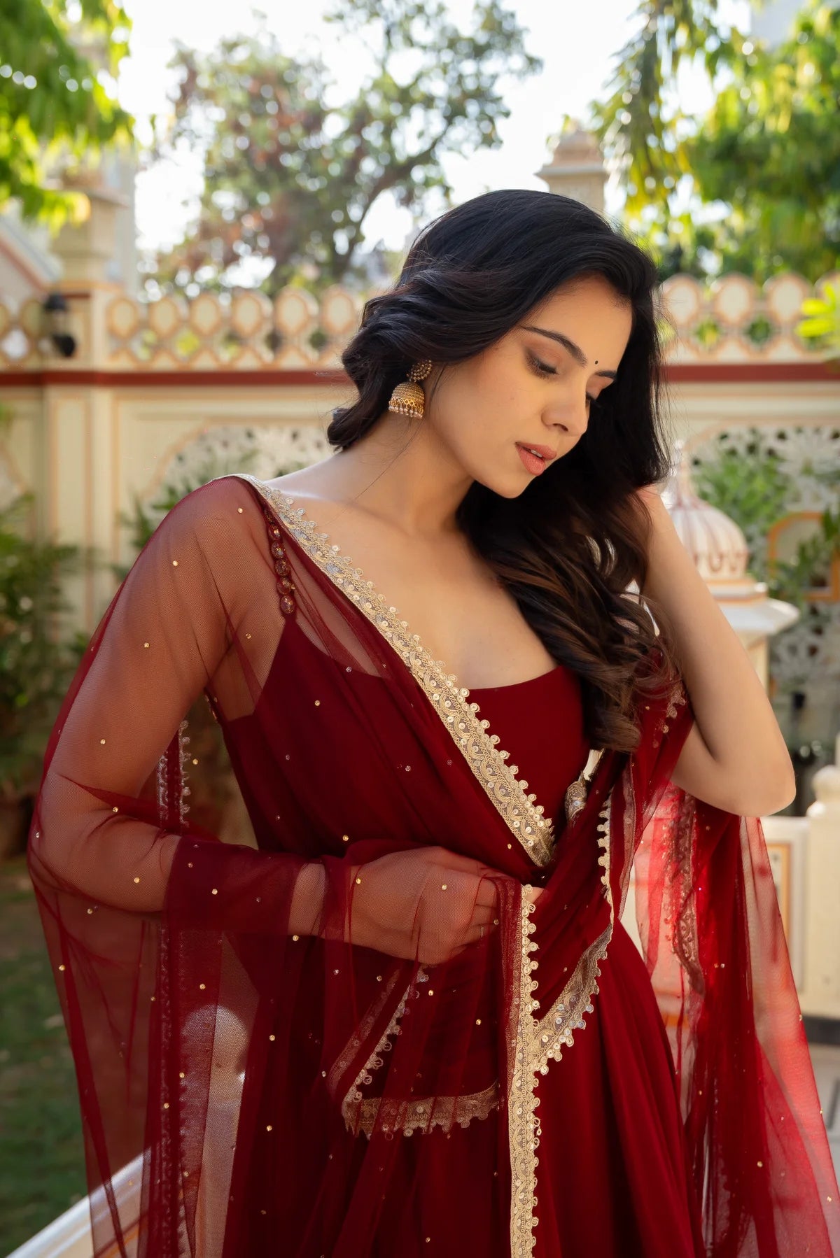 Maroon anarkali gown with sequin net dupatta and gold embroidered border - close-up drape