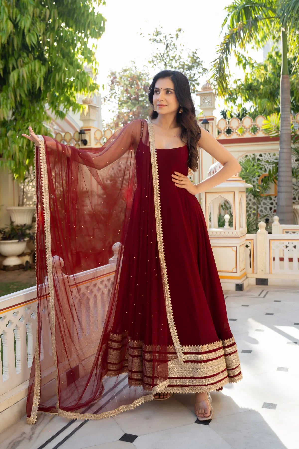 Maroon anarkali gown with net dupatta spread showing sequin work - full pose