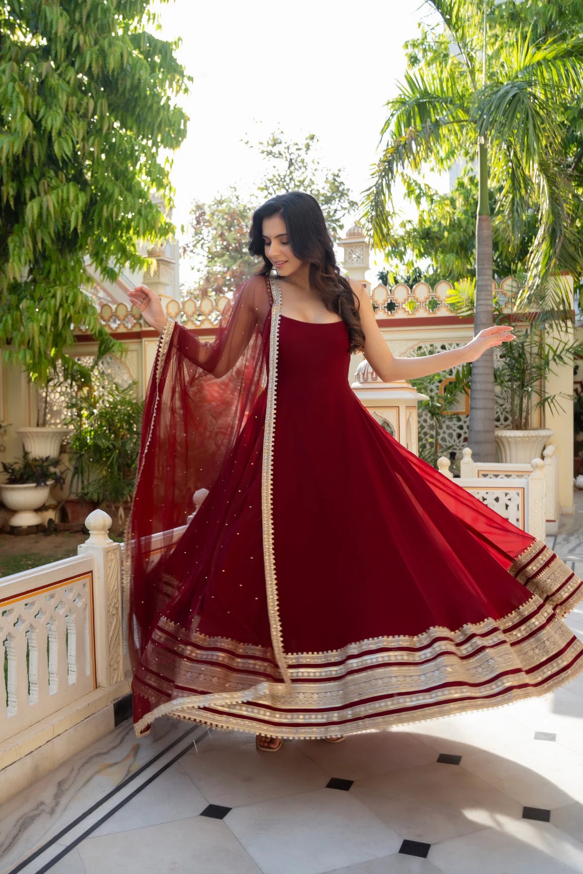 Maroon anarkali gown with floor-length georgette flare and net dupatta - twirl view