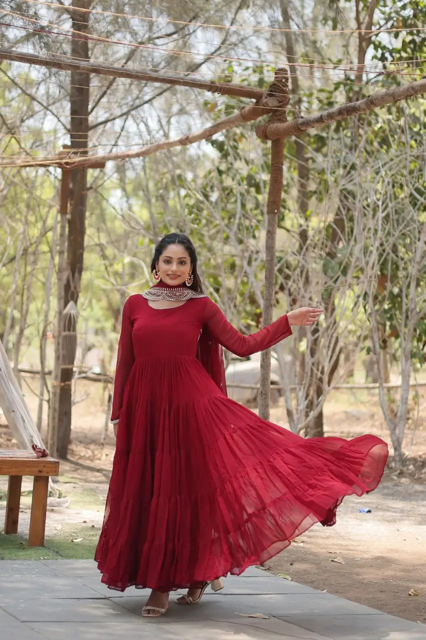 Maroon flared anarkali gown in spin pose showing tiered frill skirt movement